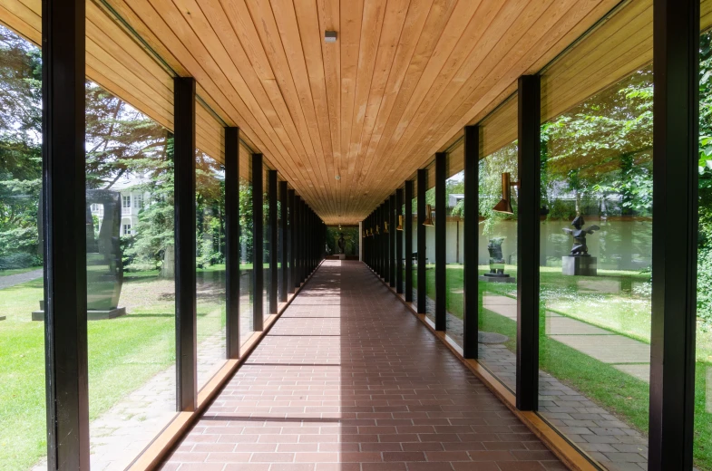 the walkway has glass panels on each side and wood planks all over it