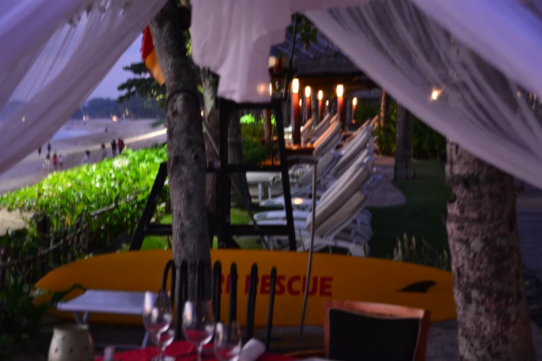 a table in the backyard under the canopy with wine glasses