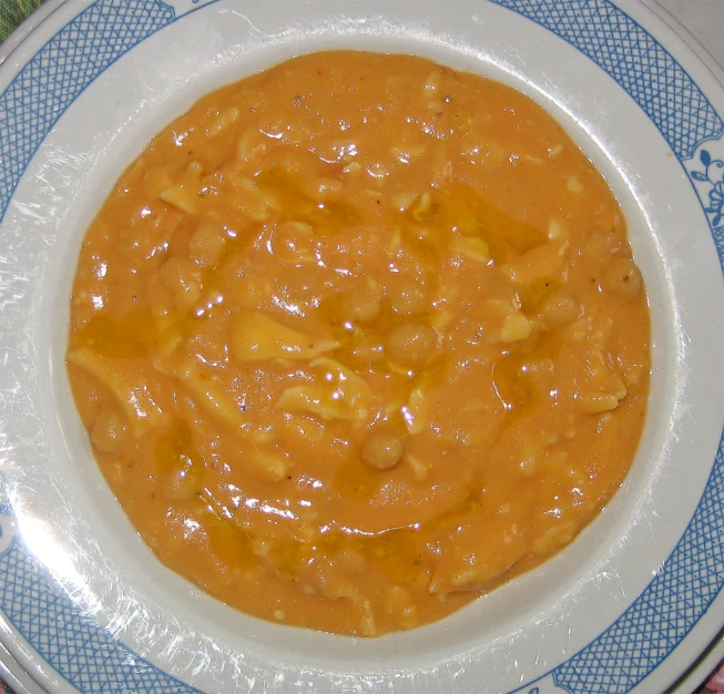 a white plate topped with orange and sauce