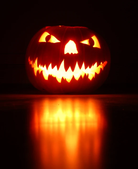 a lighted jack o lantern in the dark