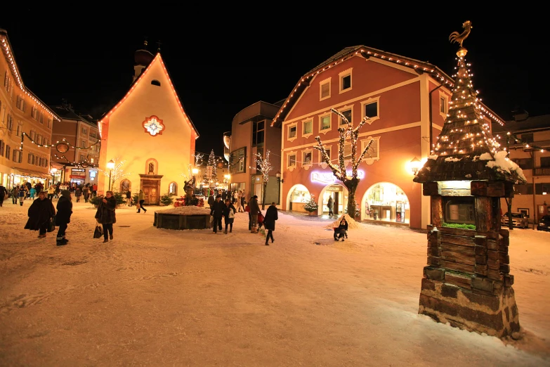 a town square is lit up for the christmas season