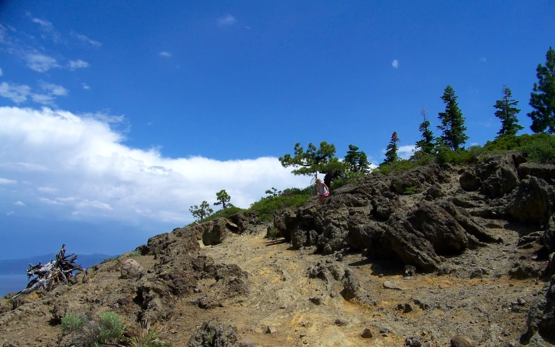 there are people riding on the mountains on motorcycles