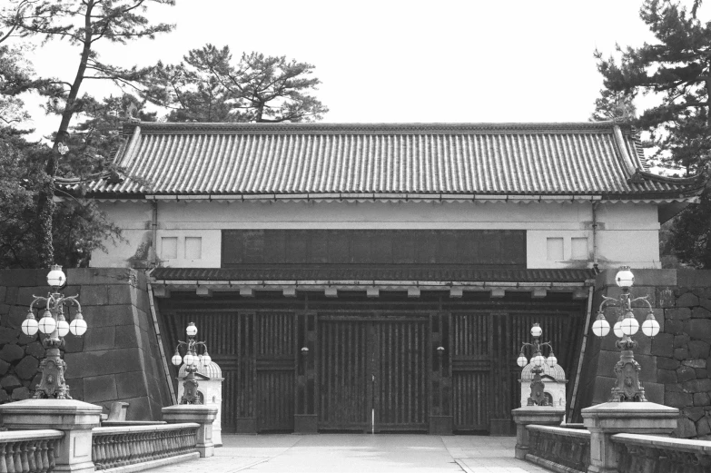 an asian temple building with statues in the courtyard