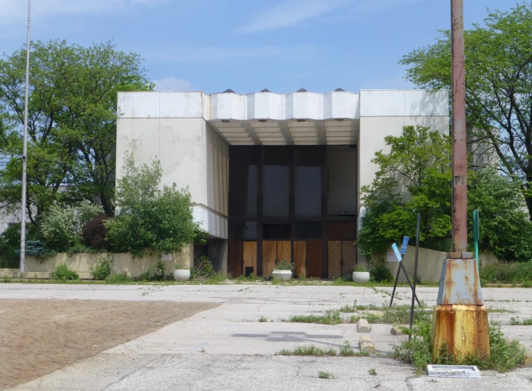 an empty building with a bunch of boarded doors in the front