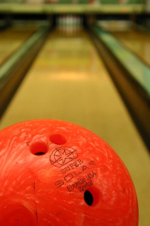 the bowling ball is close up with some graffiti on it