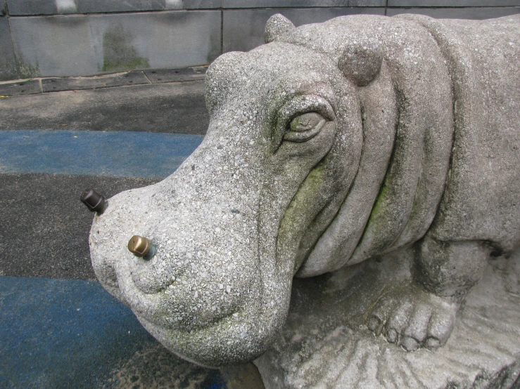 a sculpture of a hippo with its nose tilted to the side