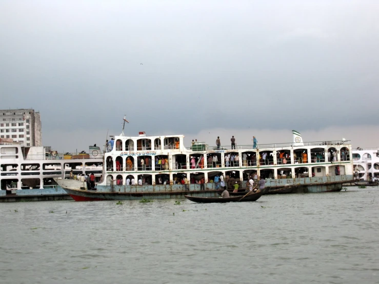 a large passenger boat is at anchor in the water