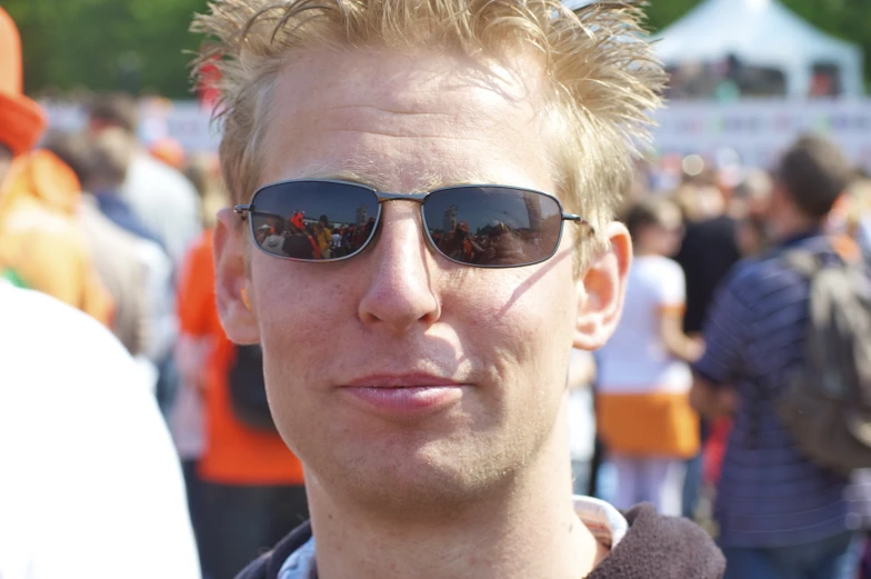 a man wearing sunglasses is posing for the camera