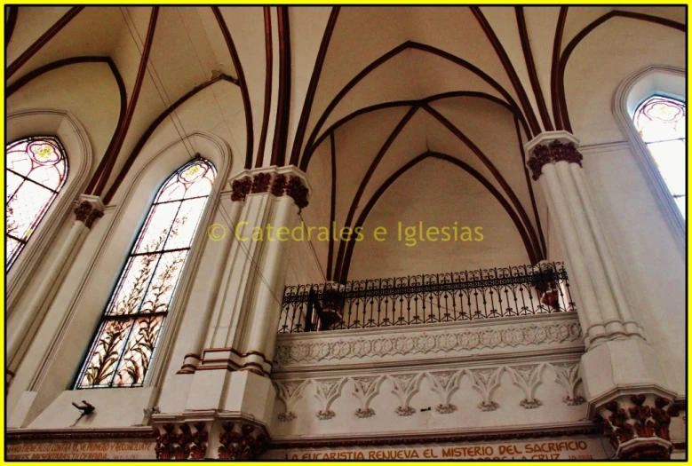 an old cathedral filled with white, brown and red stained glass windows