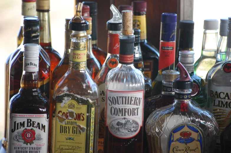 many different types and sizes of liquor sit together