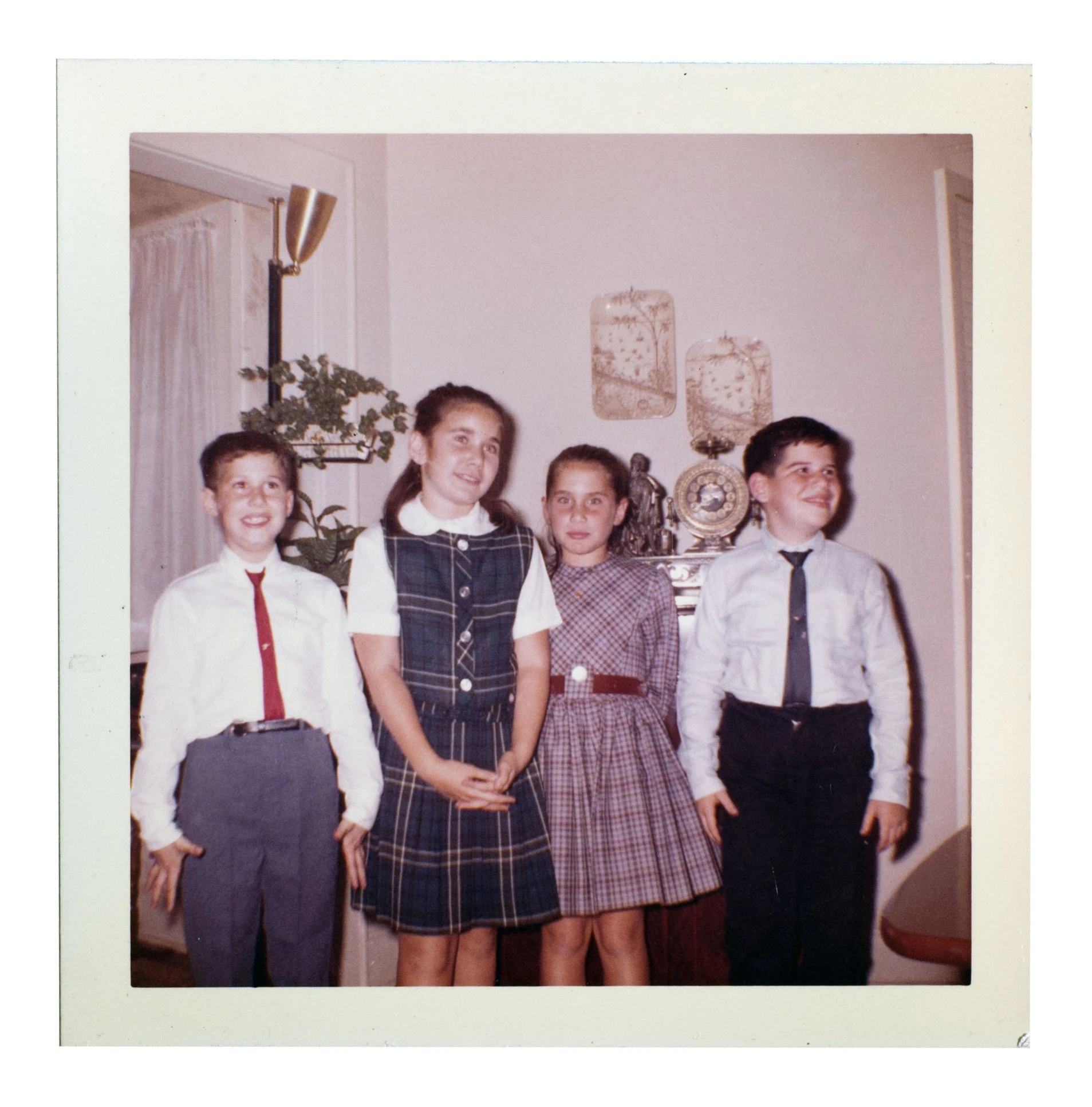 a group of children are posing in a room