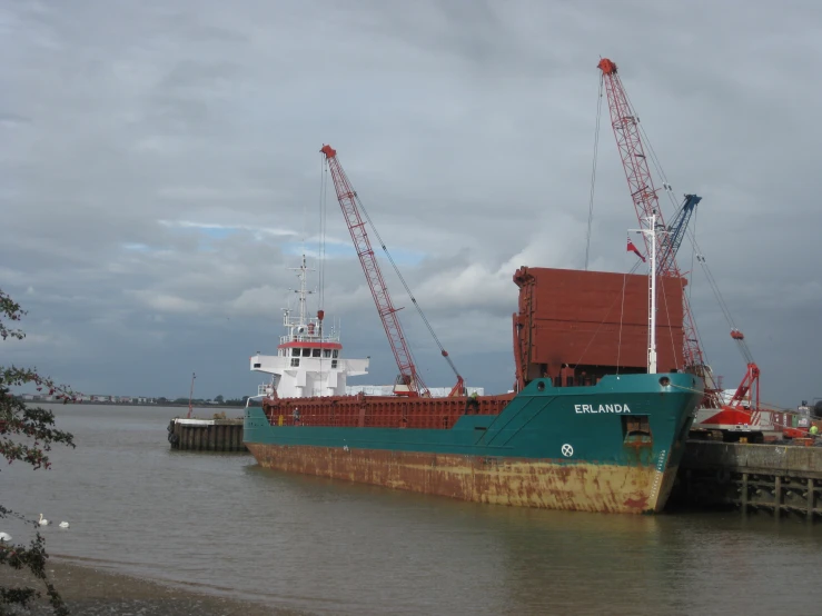 an oil rig is docked at a large body of water