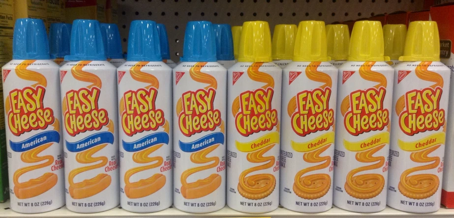 four empty canisters of fast food sitting in a store shelf