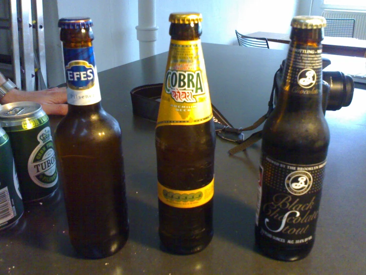 a table topped with three bottles of beer