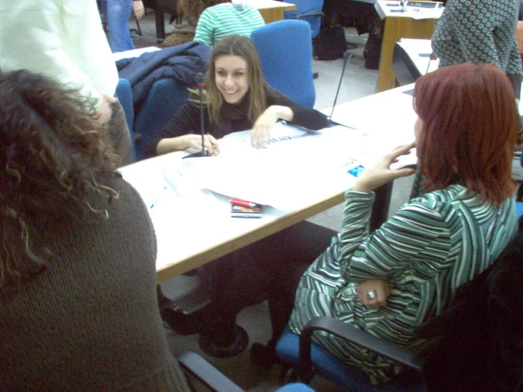 women sitting around a table having a meeting