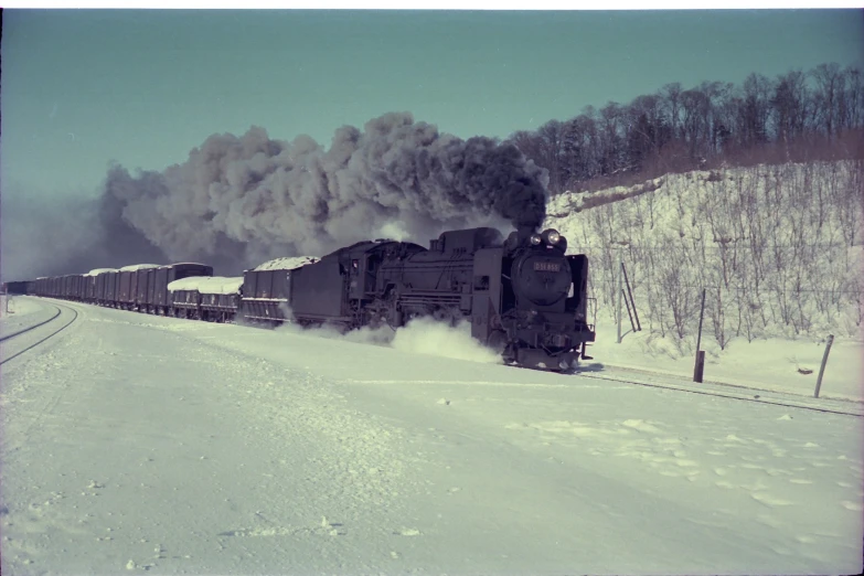 an old train is in the snow near a fence