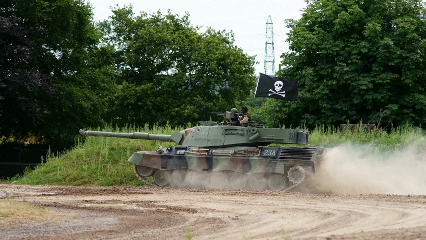 there is a large army tank moving on the dirt