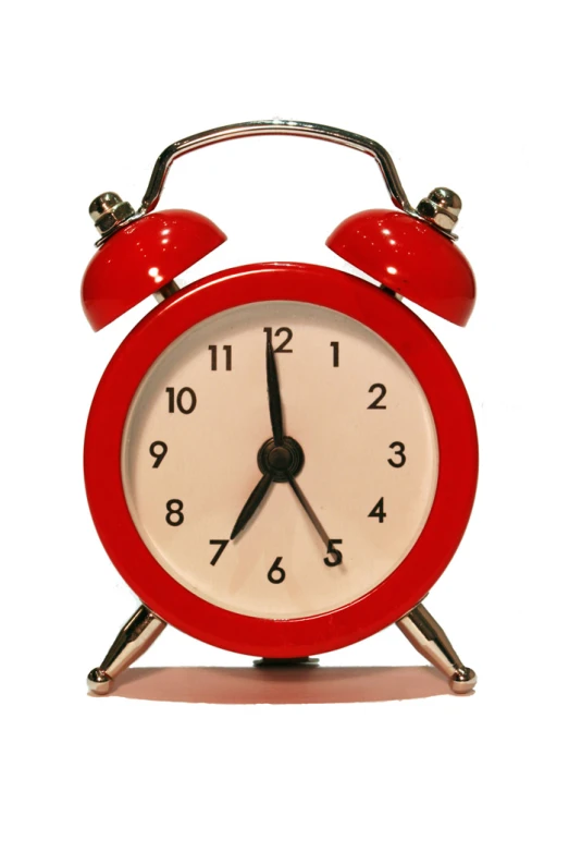 an alarm clock with three red bell and hands