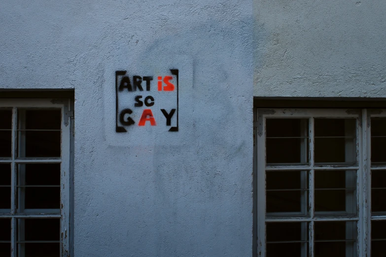 the sign on the side of a building says art is gay