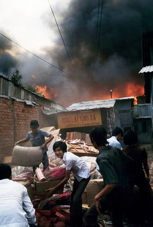 some people in front of fire with lots of smoke