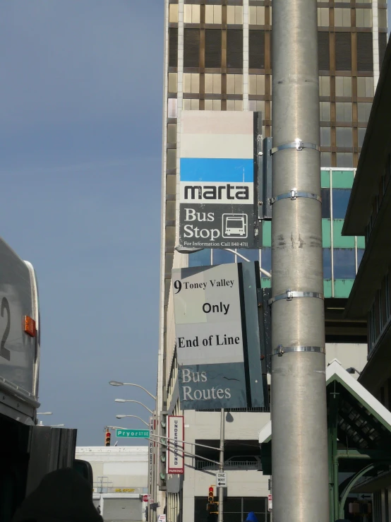 an urban intersection with a bus and billboards