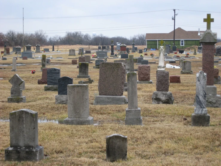 a large cemetery with various graves in a grass field