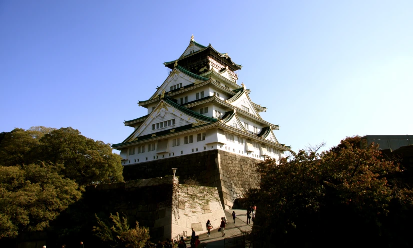 a tall building with a roof and two levels