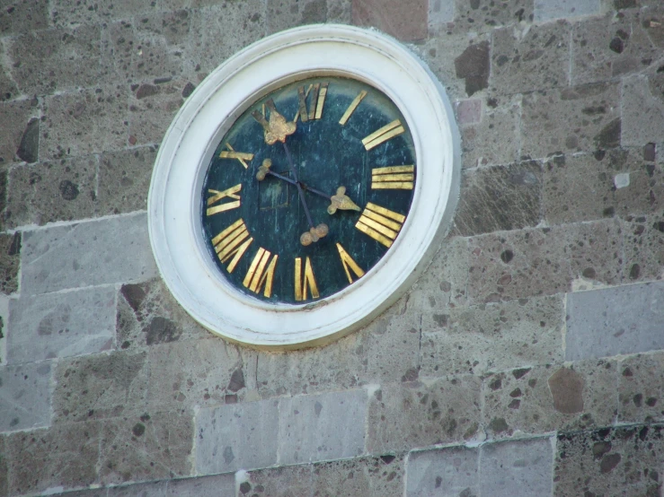 a stone building with a clock face on it