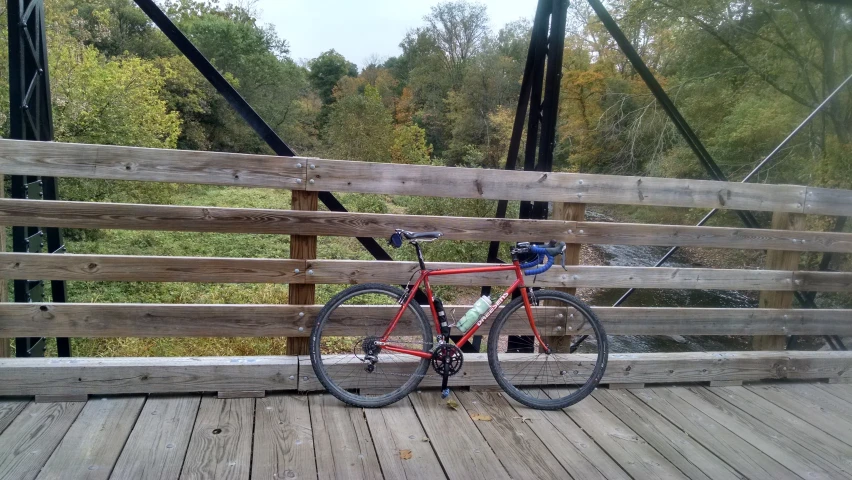 a bike is resting on a deck near a bridge