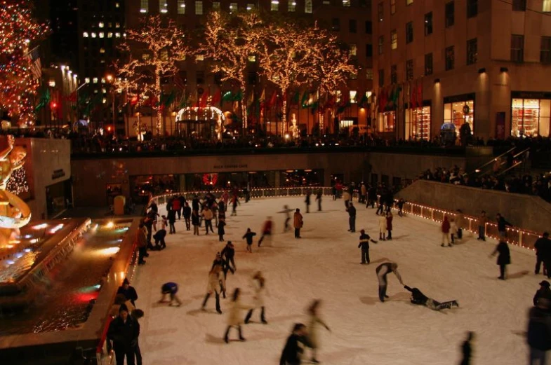 many people skating around at night outside in the city