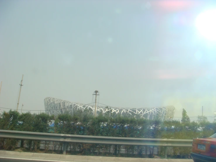 a large white object near some bushes and trees