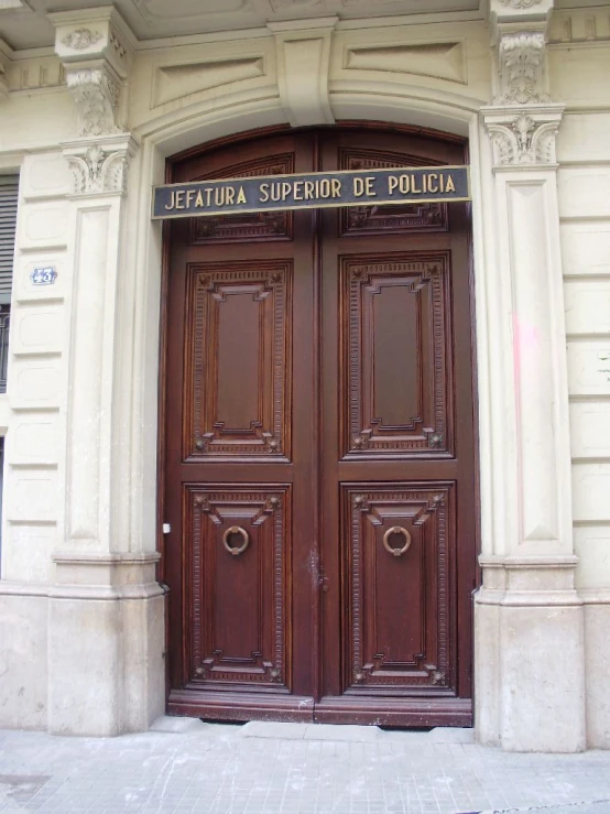 two wooden doors, are seen on a street