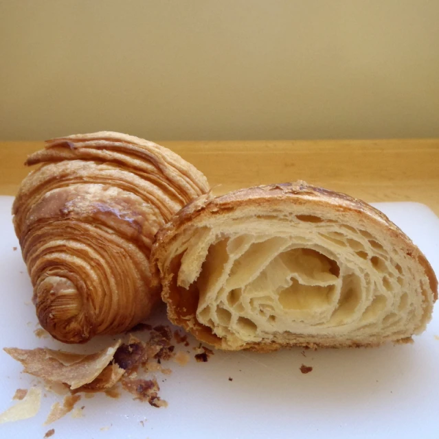 a baked item is sliced open on a  board