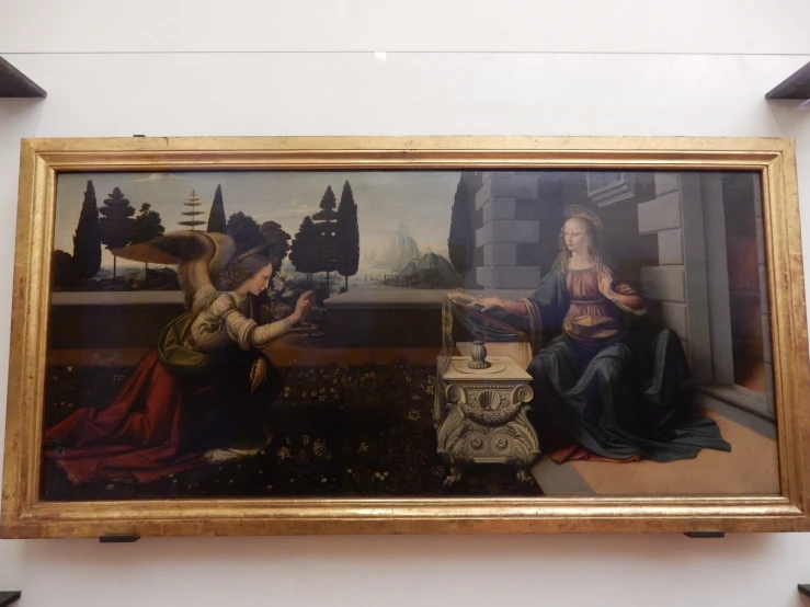 the painting is framed on a wall beside some statues