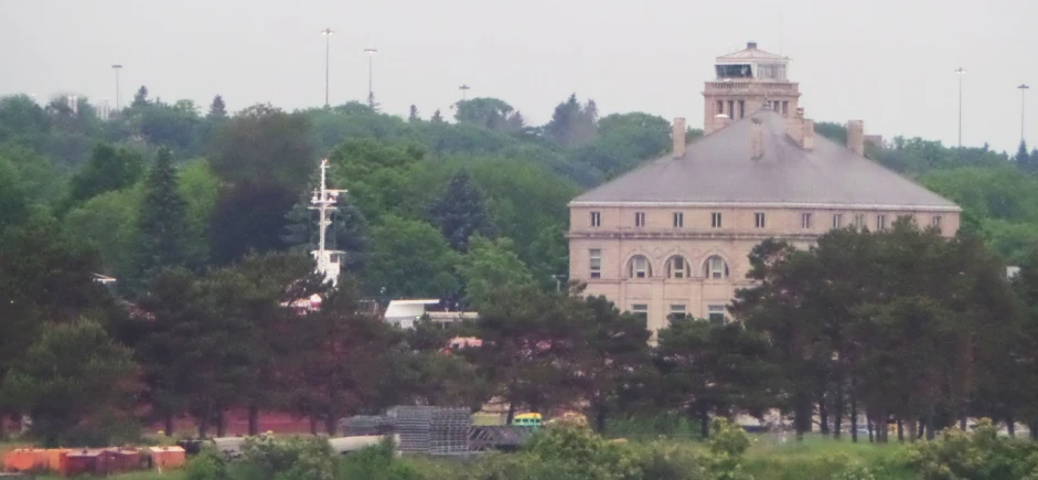 there is a very tall church sitting by the trees