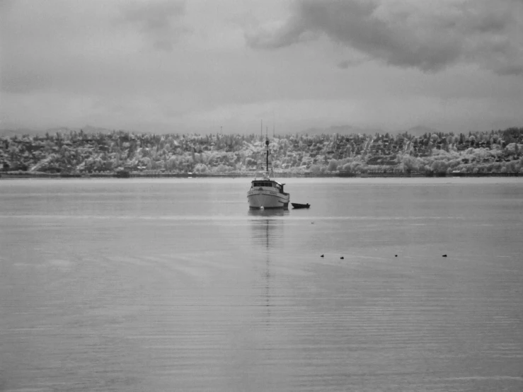 an empty boat on the lake beneath a cloudy sky