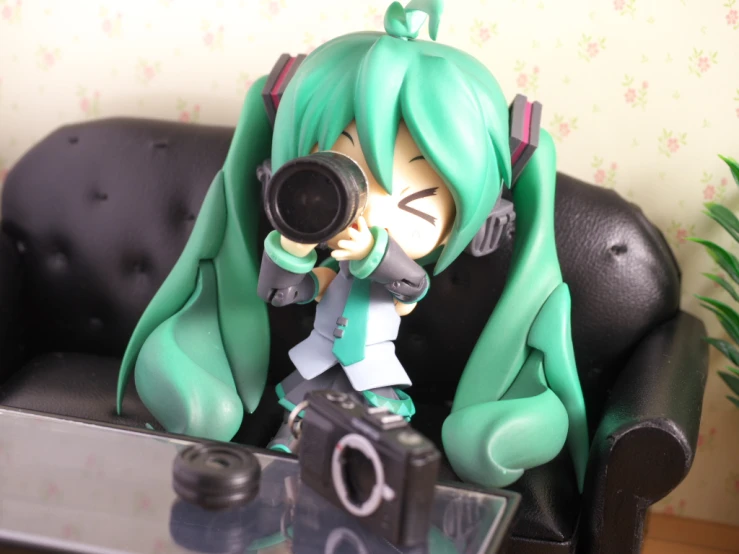 a figurine holding a camera sitting on top of a couch