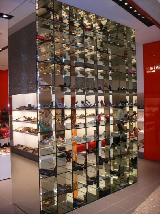 a women's shoe shop display wall full of different shoes