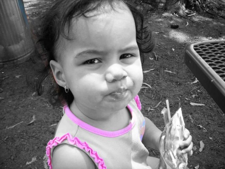 a very cute little girl eating some food