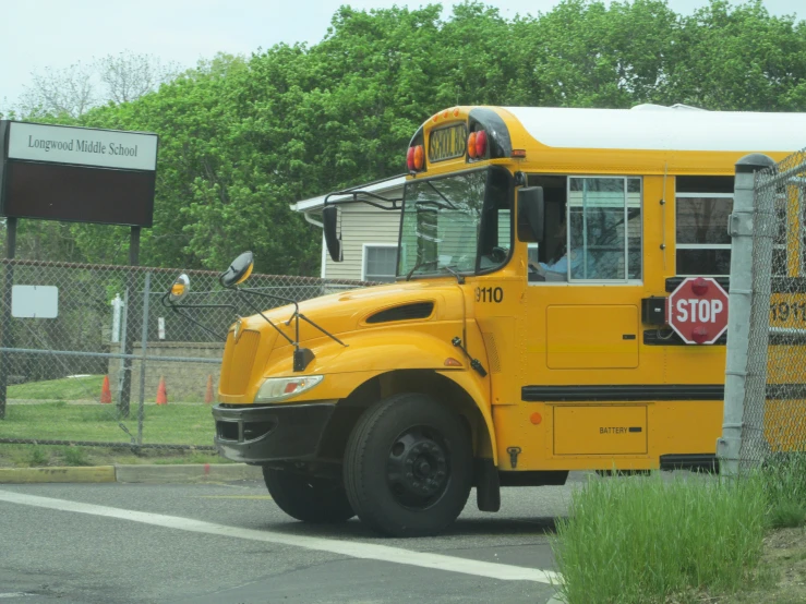 the school bus is parked at the stop