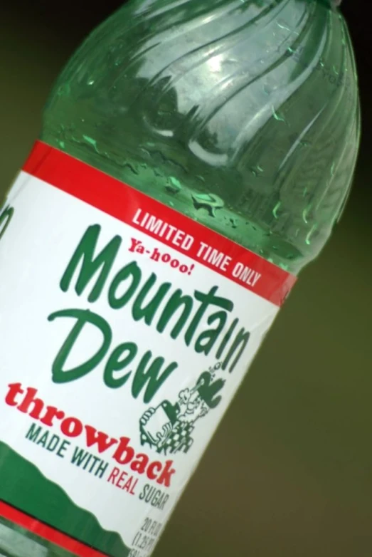 a bottle of mountain dew sits on a table