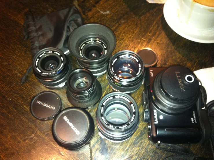 a couple of lenses sitting next to an empty camera