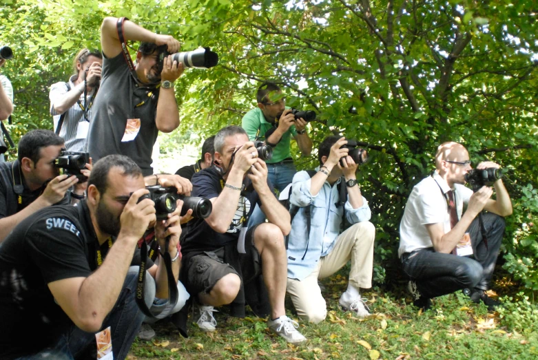 a crowd of people are taking pictures on their cell phones