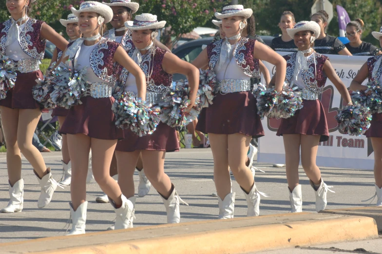 a parade with people walking around with dresses on