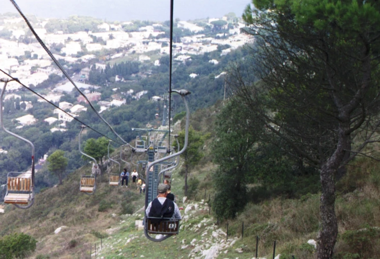 a couple of people riding up a ski slope