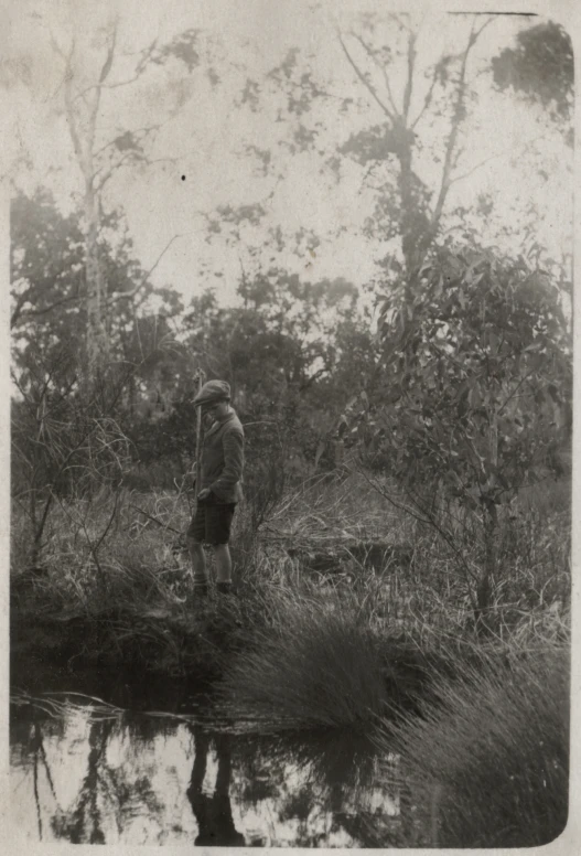 a man and child near water in an open area