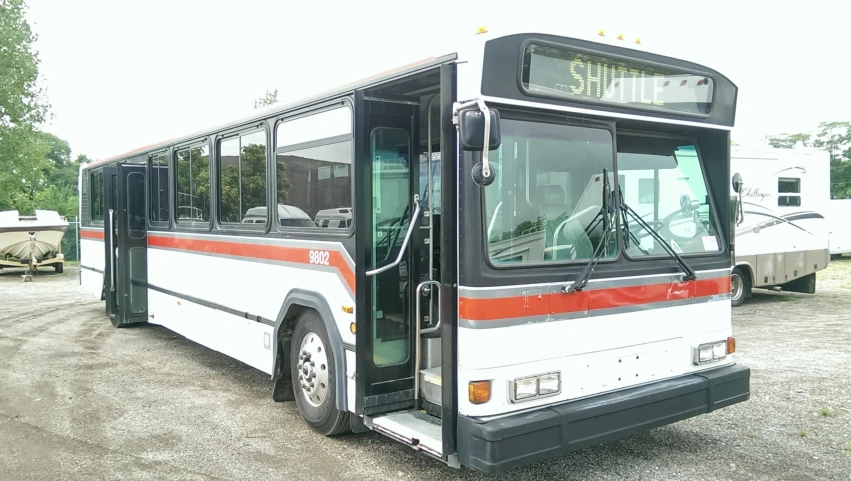 a big bus is parked near other cars