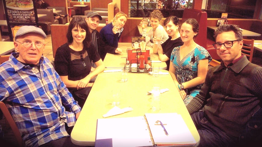 a group of people sitting at a table together