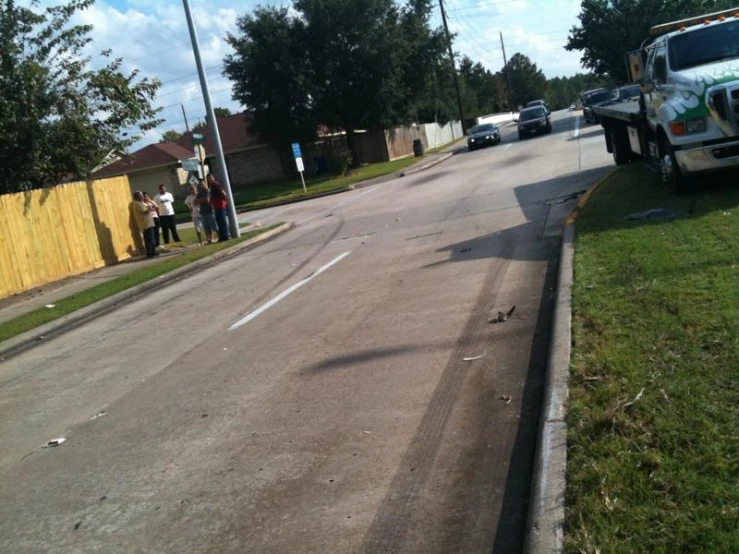 a person is standing at the corner with a broken motorcycle