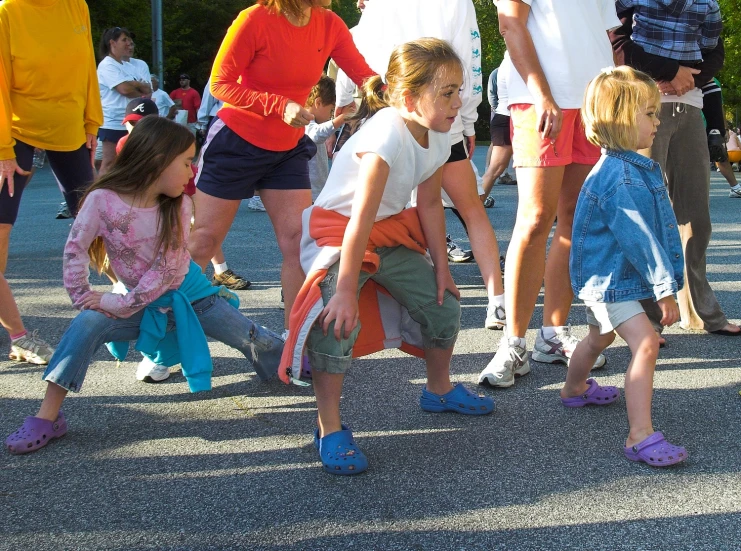 group of adults and children playing in the street